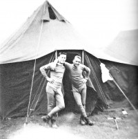 Black and white photo of two military men outside a tent